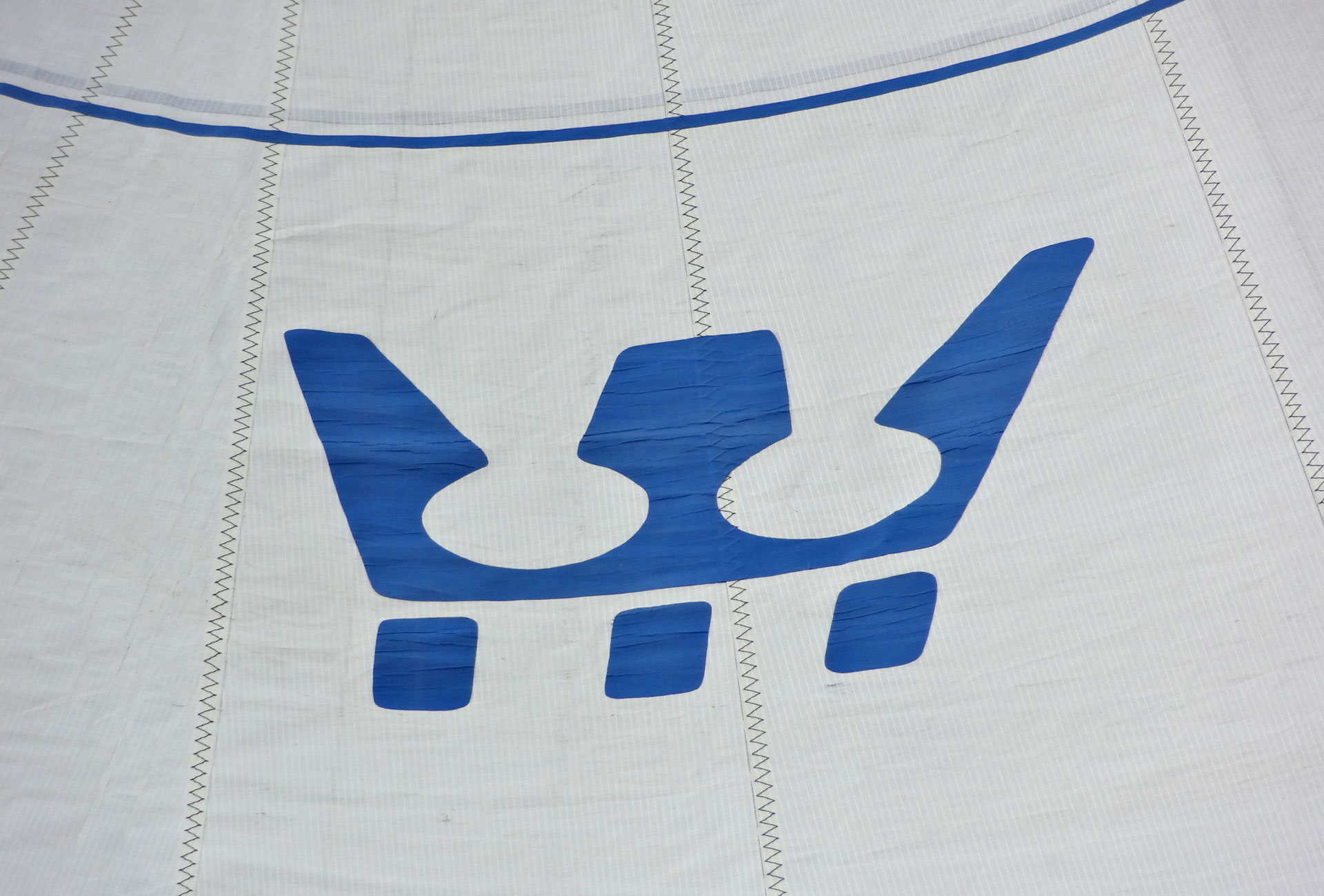 Proud white sails: The SY OLIVIA flies the insignia of her makers, Fiskars of Finland.